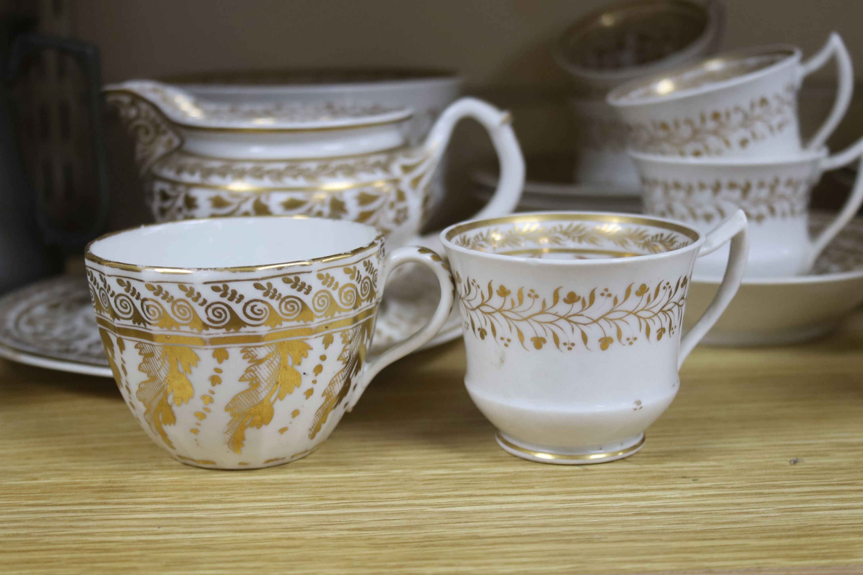 An early 19th century English porcelain gilt decorated part tea and coffee set